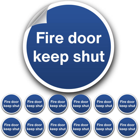 Circular blue sign with 'Fire door keep shut' text on a white background