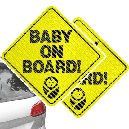 Two yellow 'Baby on Board!' signs with black text and a baby icon, one attached to a car window.